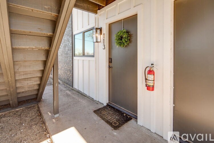 A white door with a red fire extinguisher on the right side.
