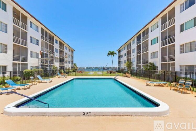 A swimming pool in a residential area with a clear blue sky.