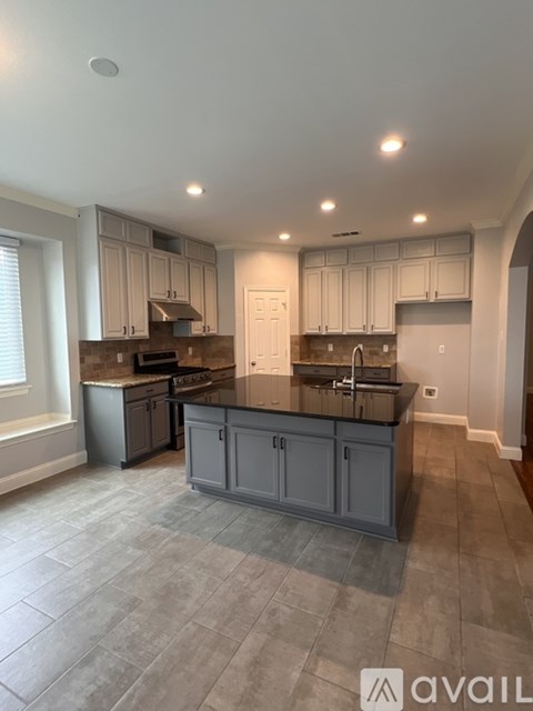 A kitchen with a large island and modern appliances.