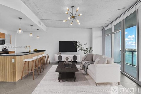 A modern living room with a bar area and a flat screen TV.