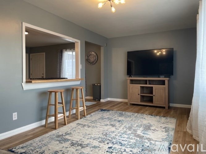 A living room with a flat screen TV and a mirror on the wall.