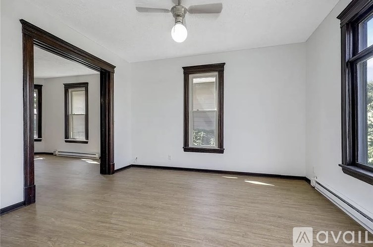 A room with a wooden floor and a ceiling fan.