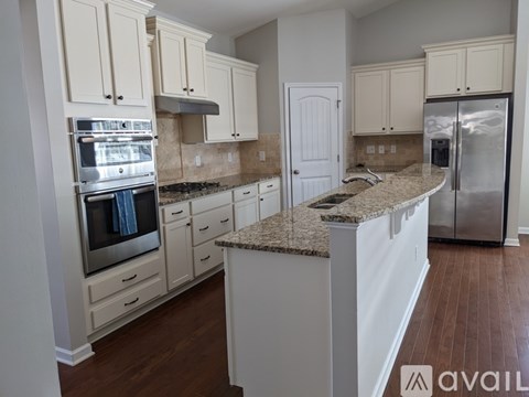 A kitchen with granite countertops and stainless steel appliances.