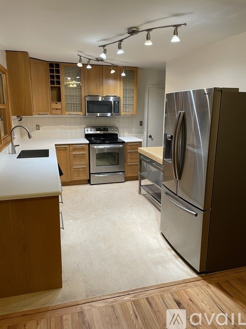 A kitchen with a refrigerator, stove, and oven.