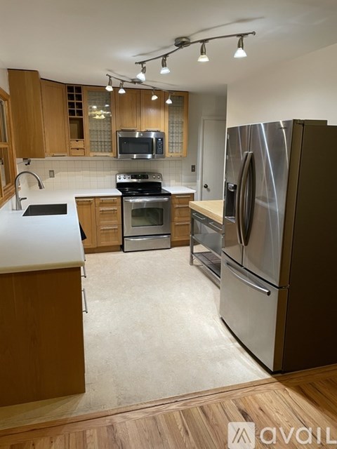 A kitchen with a refrigerator, stove, and oven.