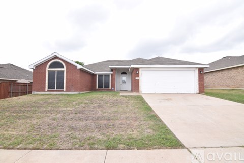 A house with a red brick exterior and a white garage door.
