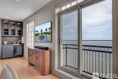 A modern living room with a television displaying a landscape scene.
