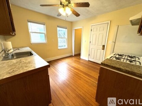 A kitchen with a counter top and a stove top oven.