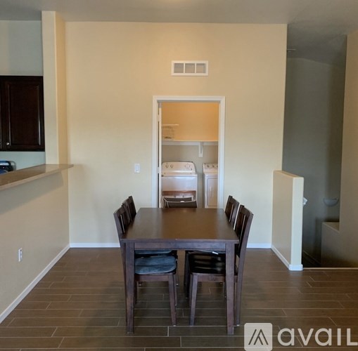 A dining room with a table and chairs is available for rent.