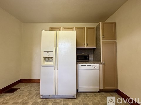 A white refrigerator with its door open in a kitchen.