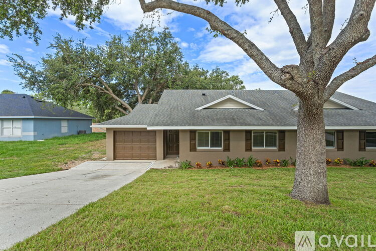 A house with a tree in front of it.
