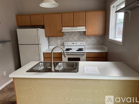 A kitchen with a white fridge and a white stove top oven.