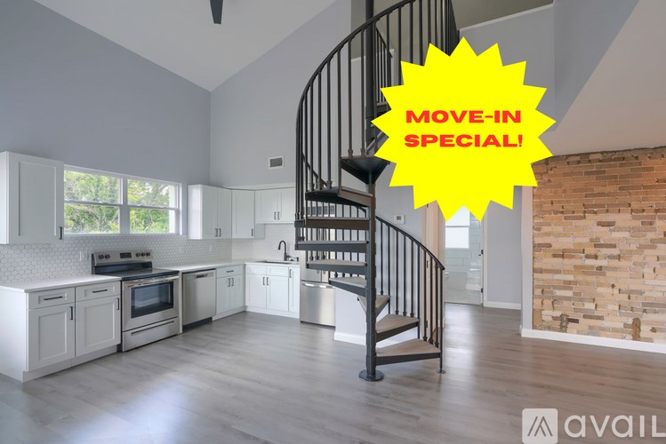 A modern kitchen with a spiral staircase and a sign that says "Move-in Special!".