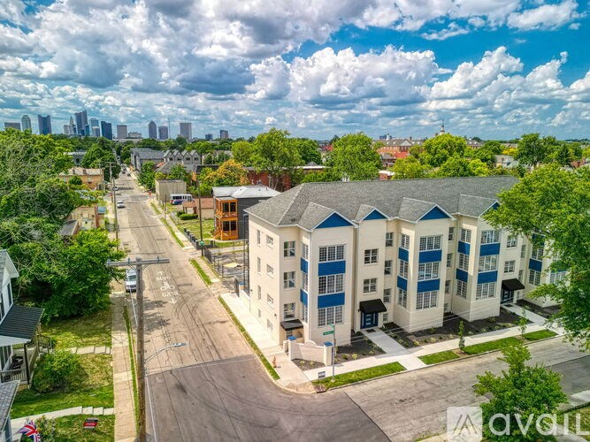 A row of townhouses with a street in front of them.