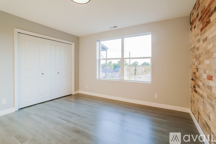A room with a brick wall and a sliding door.