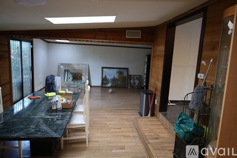 A living room with a black table and chairs.