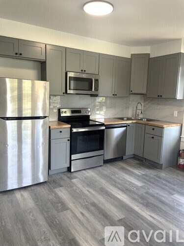 A kitchen with a stainless steel refrigerator and a stainless steel oven.