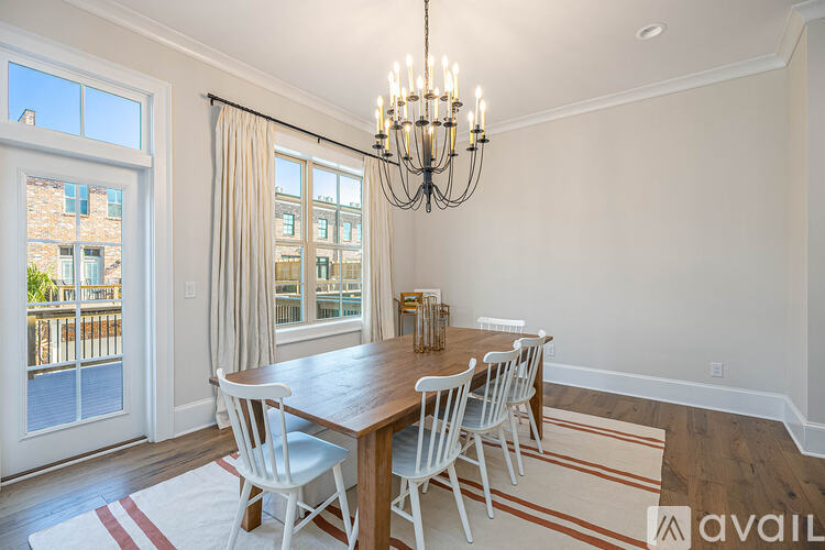 A dining room with a wooden table and chairs.