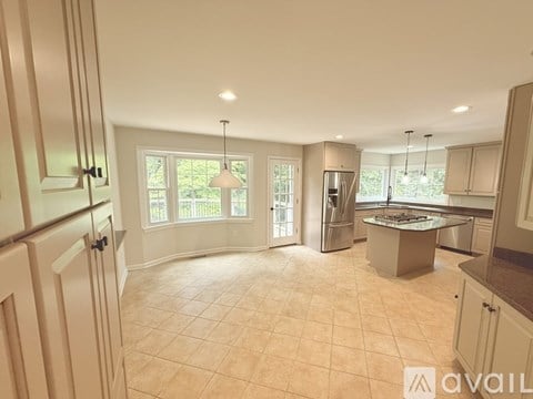A spacious kitchen with a large island in the middle.