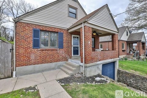 A house with a brick exterior and a blue garage door.