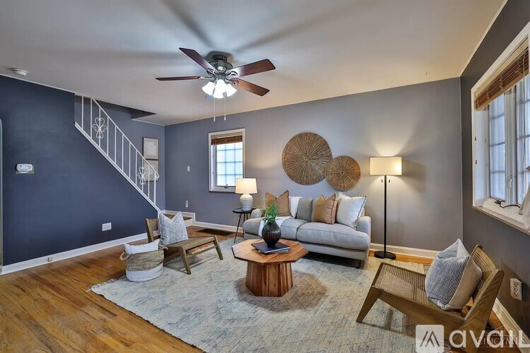 A living room with a blue wall and a wooden floor.