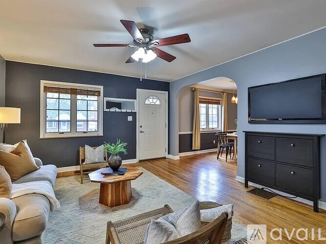 A living room with a ceiling fan and a couch.