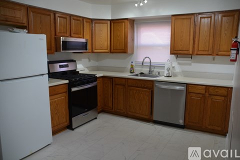 A kitchen with wooden cabinets and white appliances.