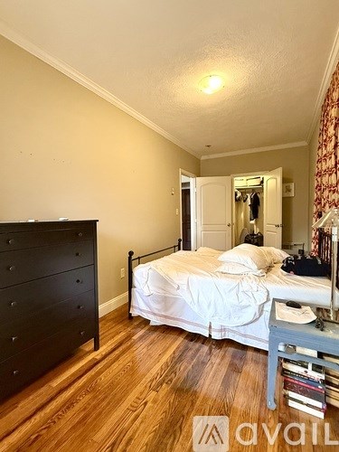 A bedroom with a bed, dresser, and mirror.