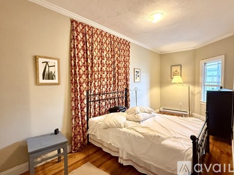 A living room with a fireplace, a mirror, a chair, and a coffee table.