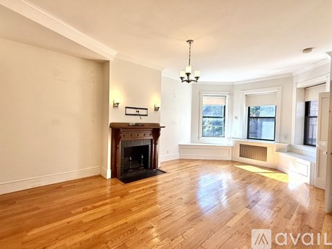 A living room with a fireplace and a television.