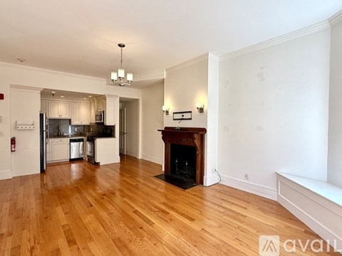 A kitchen with a fridge and a stove top oven.