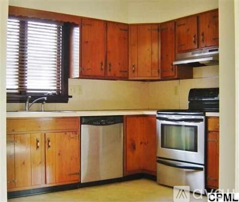 A kitchen with wooden cabinets and stainless steel appliances.