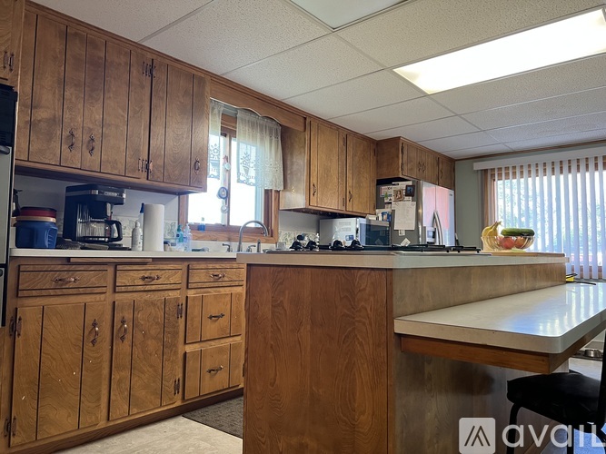 A kitchen with wooden cabinets and a countertop.