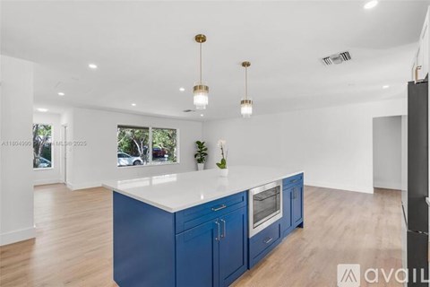 A kitchen with blue cabinets and a white countertop.