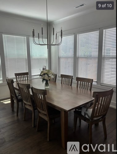 A dining room with a table set for six.