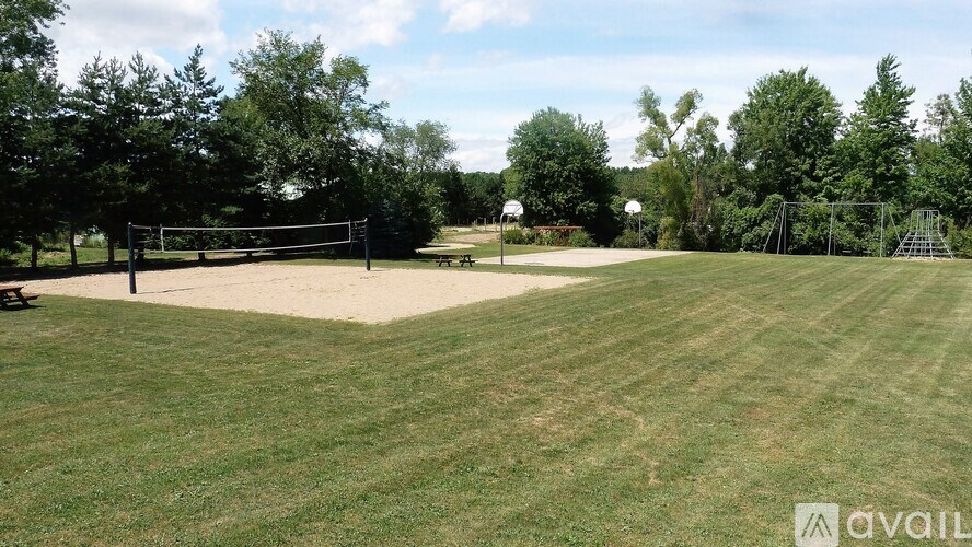 A volleyball net is set up on a grassy field.