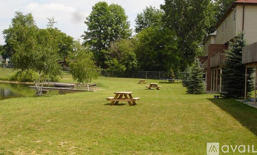 A picnic table is in the middle of a grassy field.