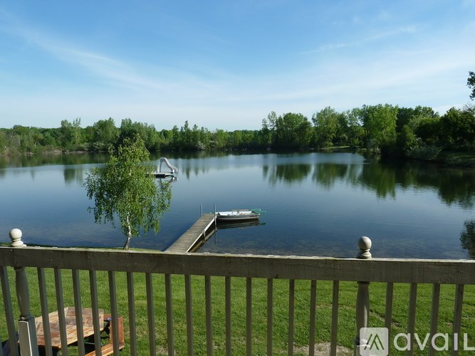 A lake with a dock and a boat on it.