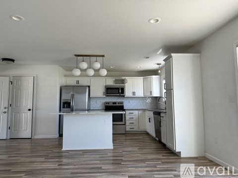 A modern kitchen with white cabinets and a center island.