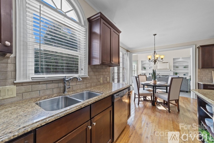 A kitchen with wooden cabinets and a granite countertop.