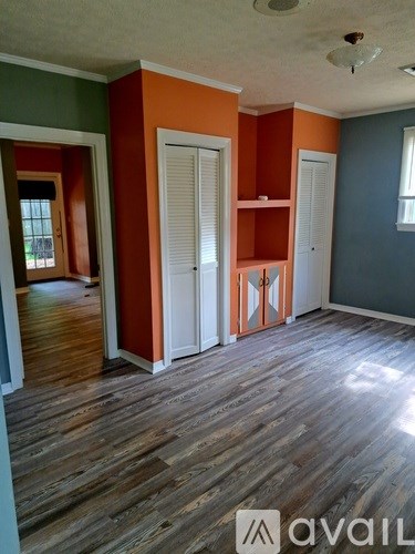 A room with wooden floors and a white ceiling.