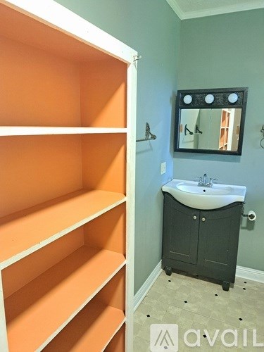 A bathroom with a sink and a medicine cabinet.