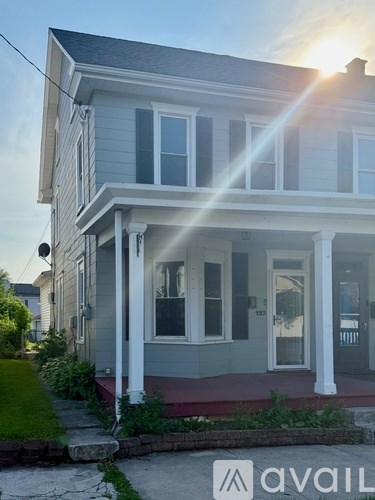 A house with a porch and a sign that says "avail".