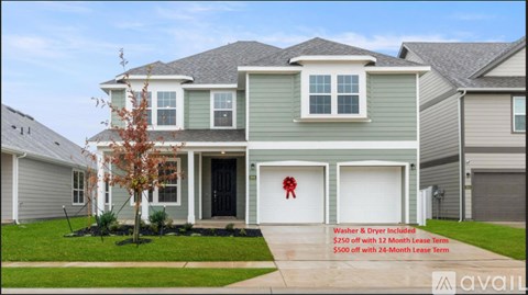 A house with a red bow on the door and a washer and dryer included.