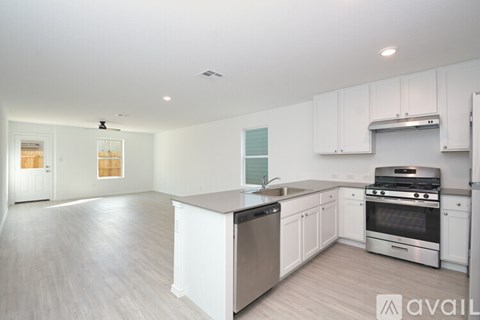 A kitchen with white cabinets and stainless steel appliances.