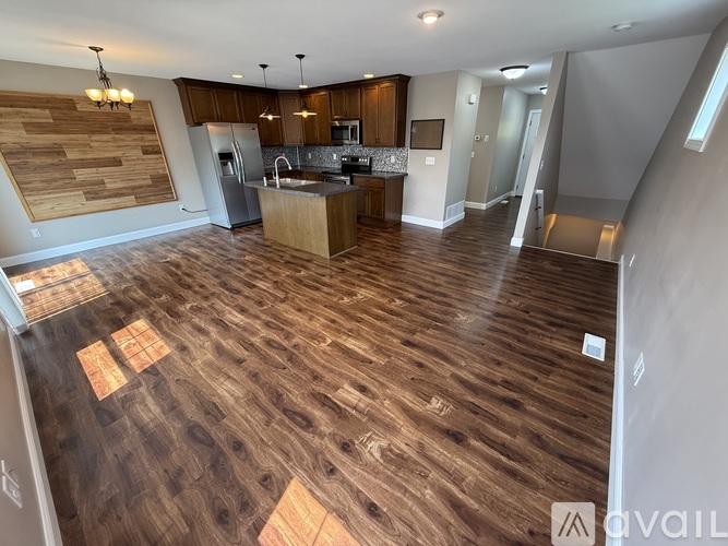 A kitchen with wooden floors and a wooden wall.