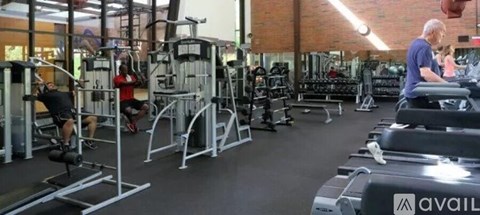 A man is working out on a treadmill in a gym.