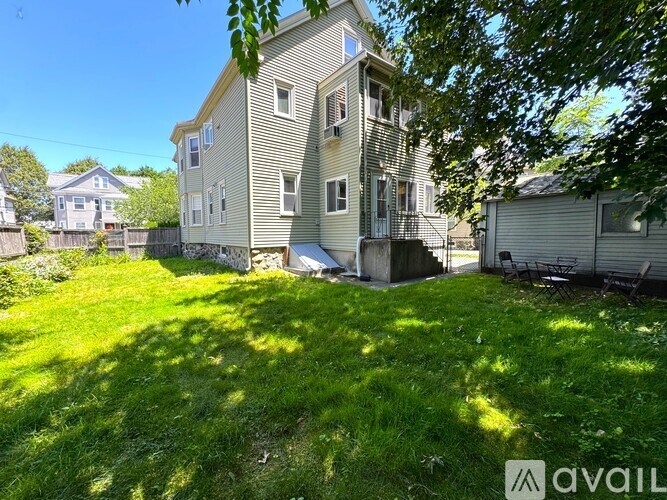 A house with a green lawn in front of it.
