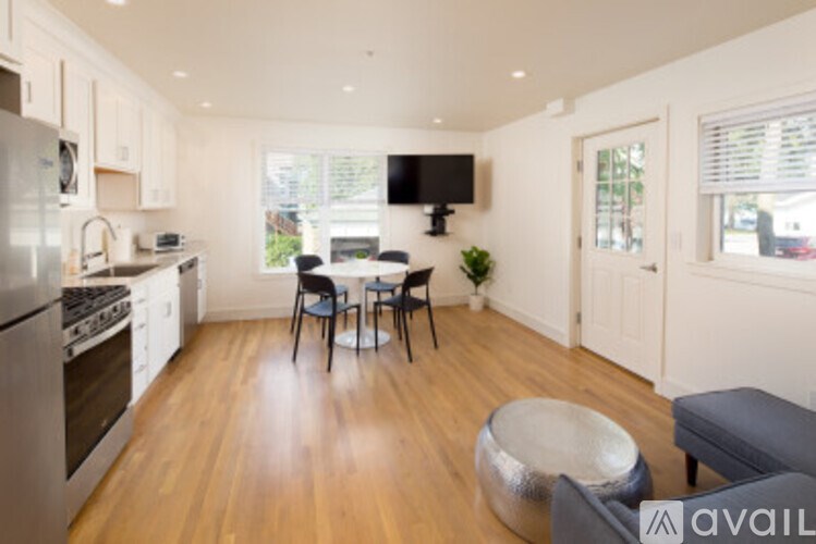 A kitchen with a table and chairs in the middle of the room.