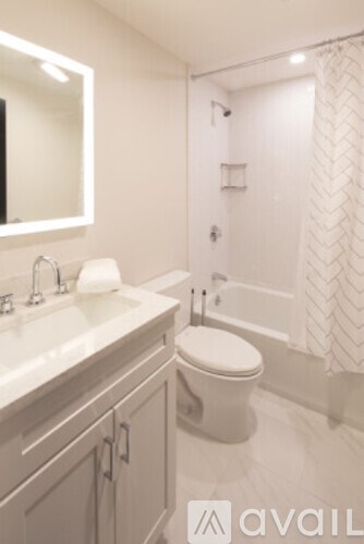 A bathroom with a toilet, sink, and bathtub.